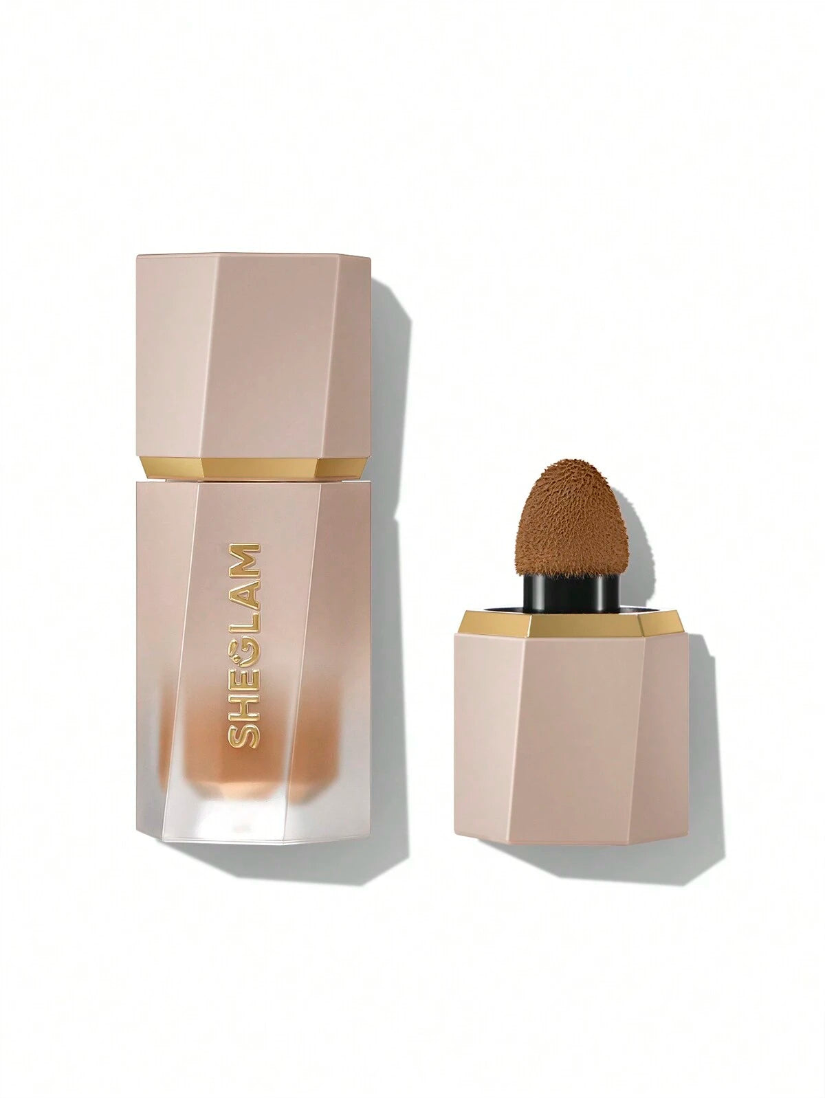 A liquid contour product by SHEGLAM with a beige packaging and a golden cap, displayed with the product visible through an open lid.